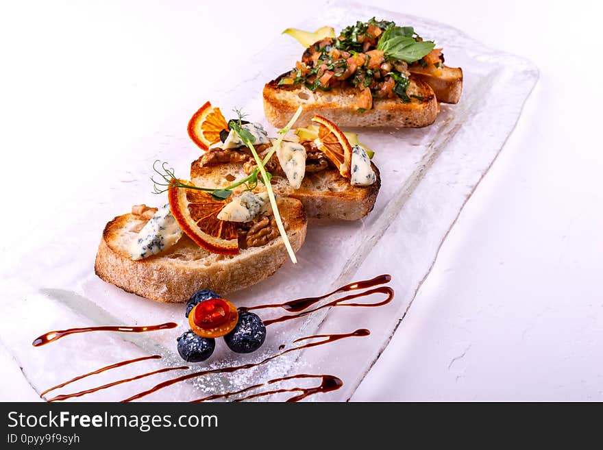 Delicious Italian antipasti bruschetta on white background. Close-up.