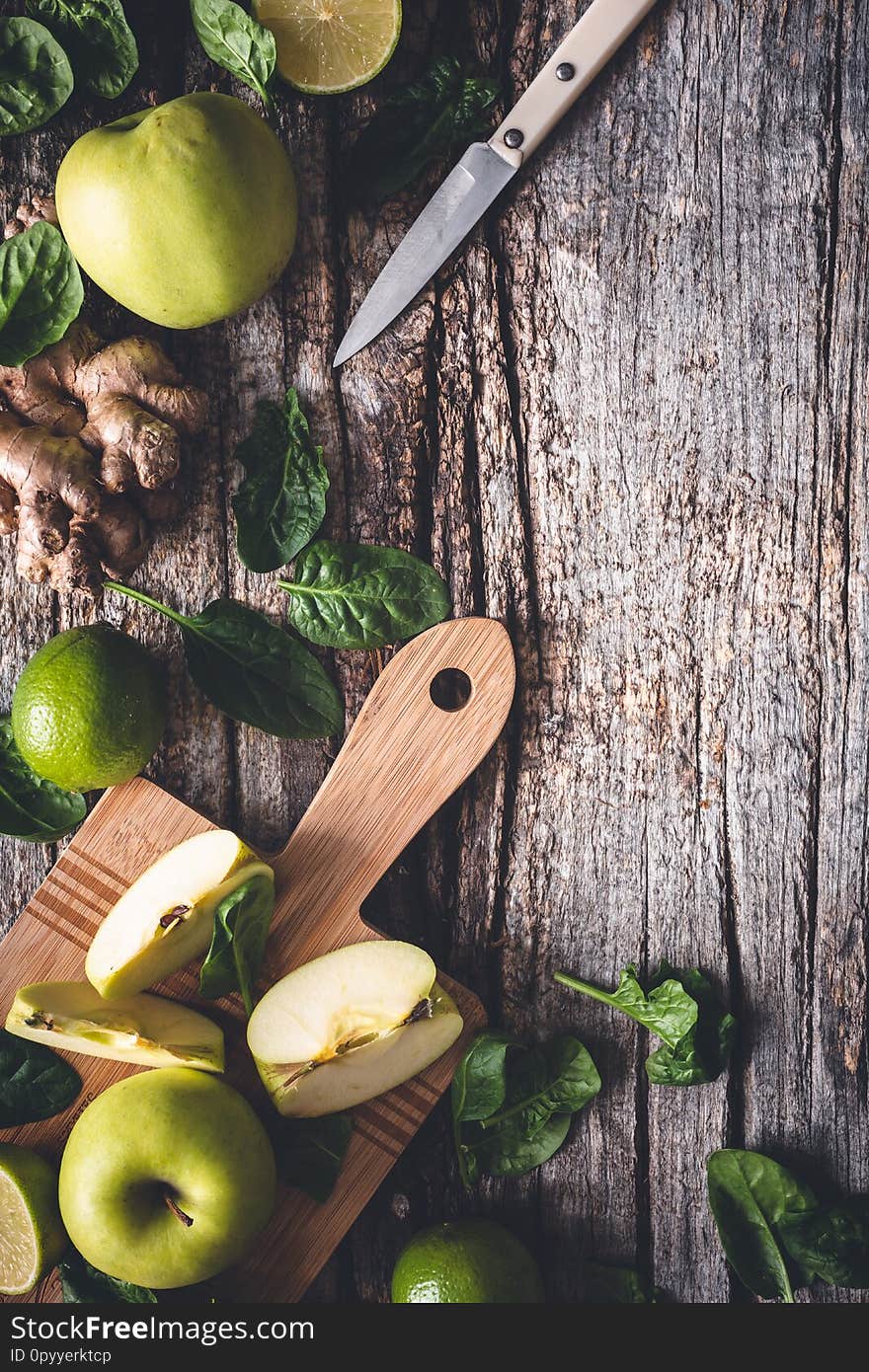 Ingredients for Green Smoothie with Spinach, Apple, Lime and Ginger. Healthy Drink on wooden background