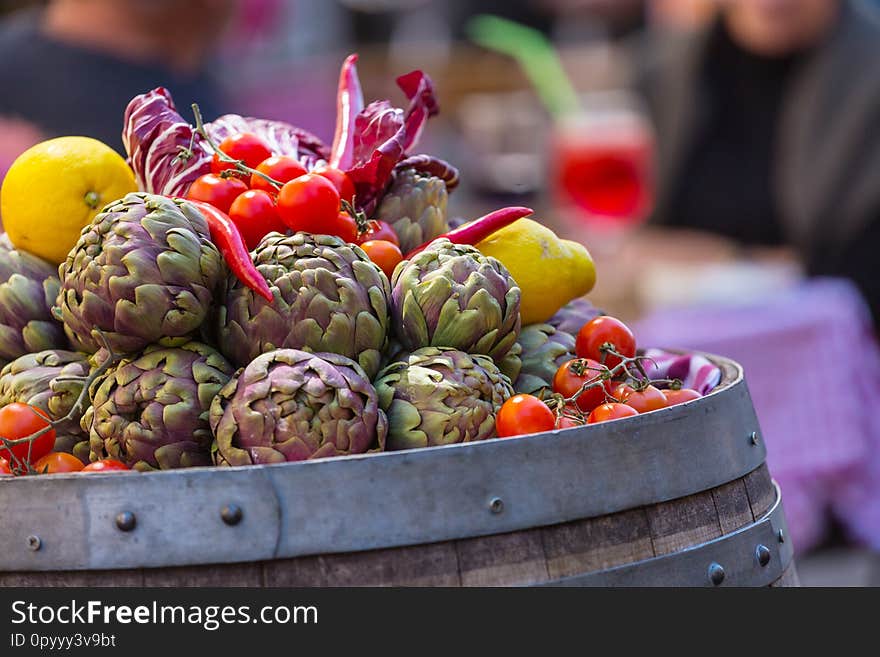 Fresh artichokes and tomatoes at farmers market