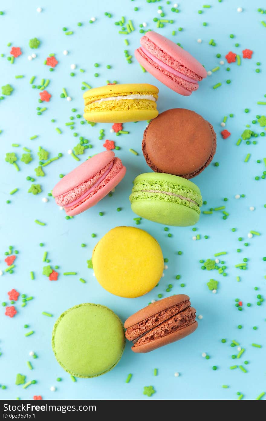 Macarons. French Multicolored Macaroons Cakes. Small French Sweet Cake On Bright Blue Background. Dessert. Sweets. Top View