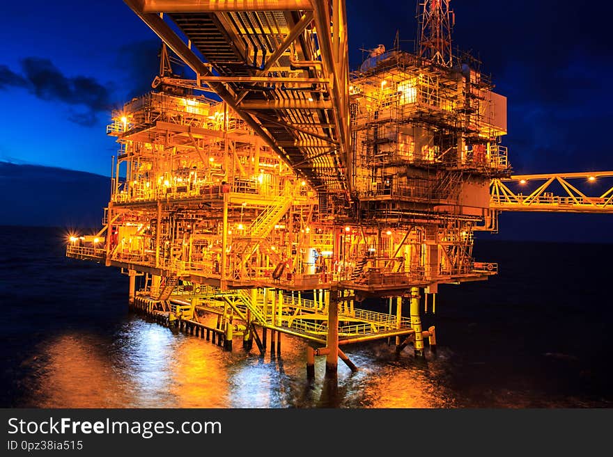 The large offshore oil rig at night with twilight background. The large offshore oil rig at night with twilight background