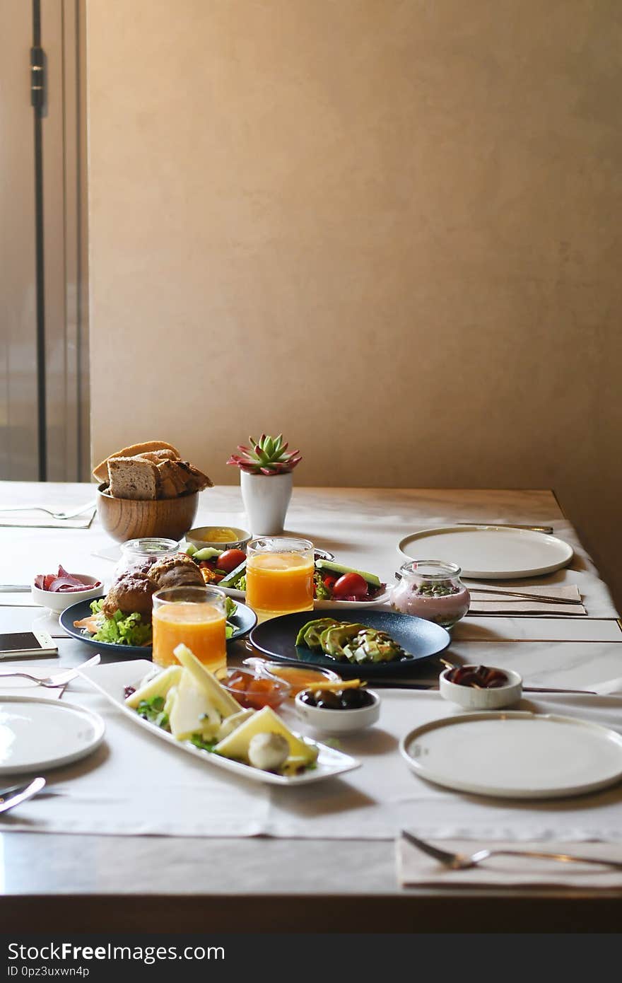 Delicious Food Served On Various Plates On A Table