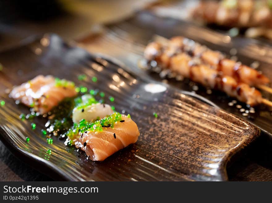 Salmon and sea bream sushi and tuna skewers of typical Japanese cuisine. Salmon and sea bream sushi and tuna skewers of typical Japanese cuisine