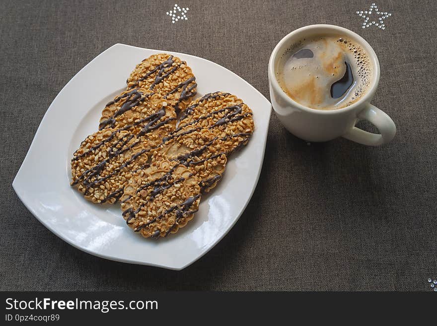 Coffee in cup whith cookies in the plate on dark background. Coffee in cup whith cookies in the plate on dark background