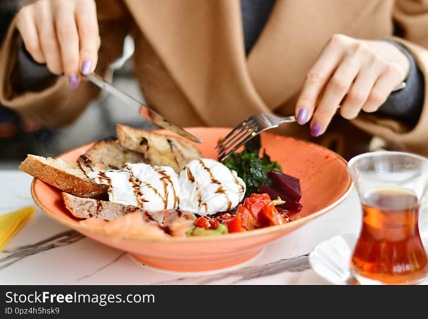 Female hands over plate with food holding fork and knife, healthy eating concept. Female hands over plate with food holding fork and knife, healthy eating concept