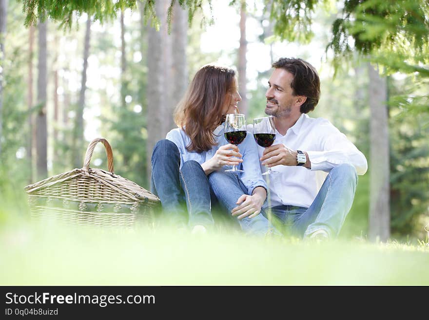 Young beautiful couple on picnic in summer park