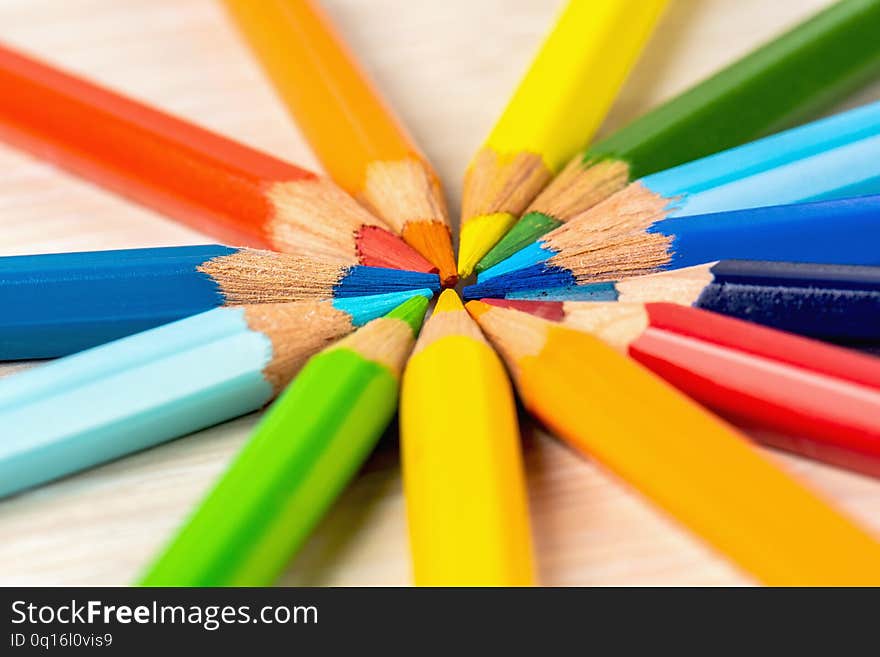 Color pencils in a circle on a white background. Drawing with colored pencils