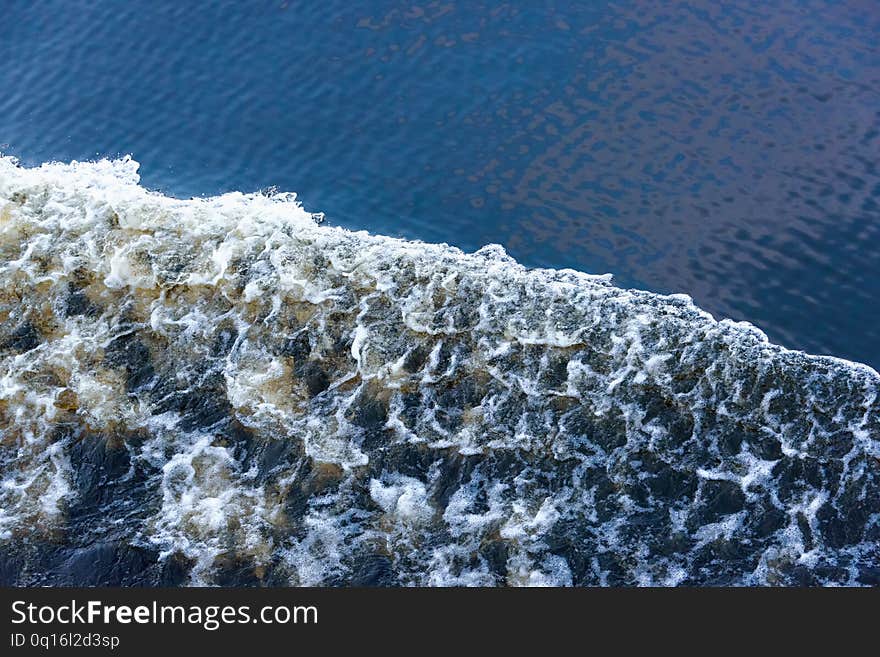 Boiling track on the water of the river from the movement of the ship .