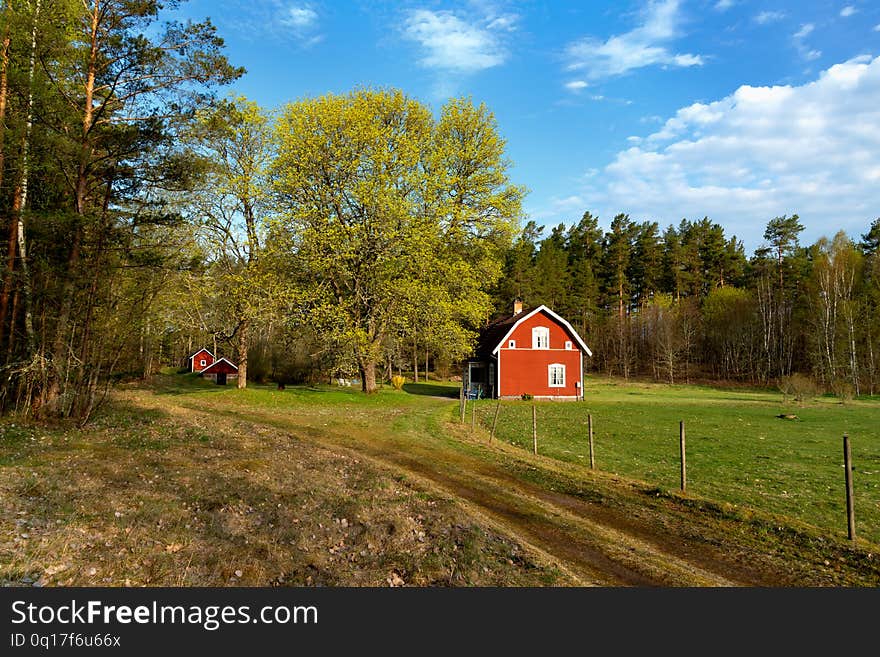 Typical red wooden cottage in Sweden in spring. Smaland, south-east Sweden. Typical red wooden cottage in Sweden in spring. Smaland, south-east Sweden