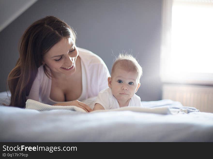 Her pride and happiness. Mother and baby on bed. Close up. Copy space