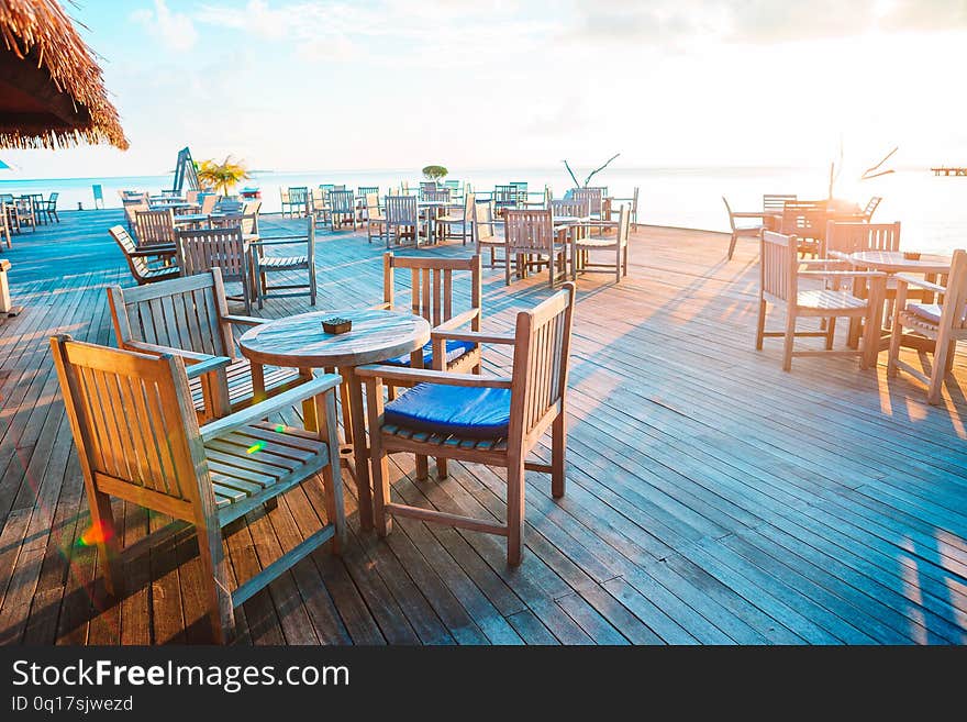 Summer empty open air cafe at exotic island at sunset. Summer empty open air cafe at exotic island at sunset