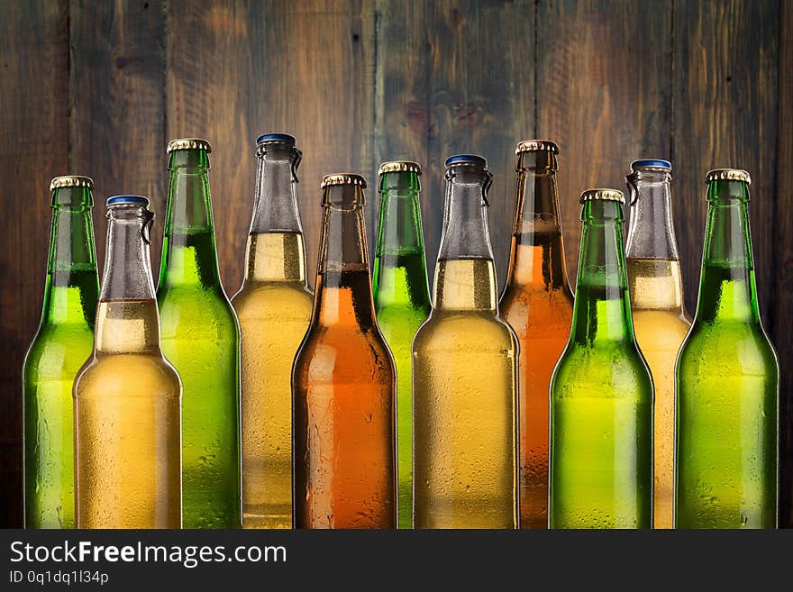 Group of cold wet beer bottles on the grunge background