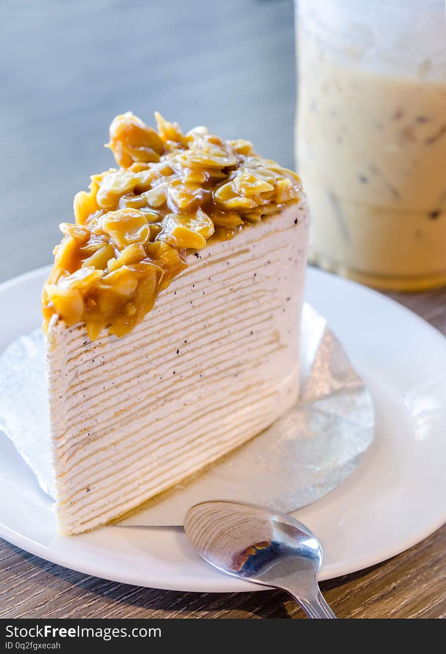 Cut a piece salted caramel crepe cake with nuts