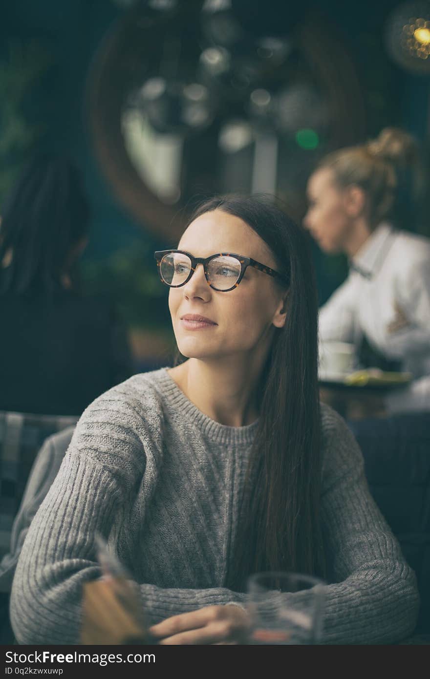 Portrait of pretty young woman in cafe, looking through window and waiting for someone. Portrait of pretty young woman in cafe, looking through window and waiting for someone