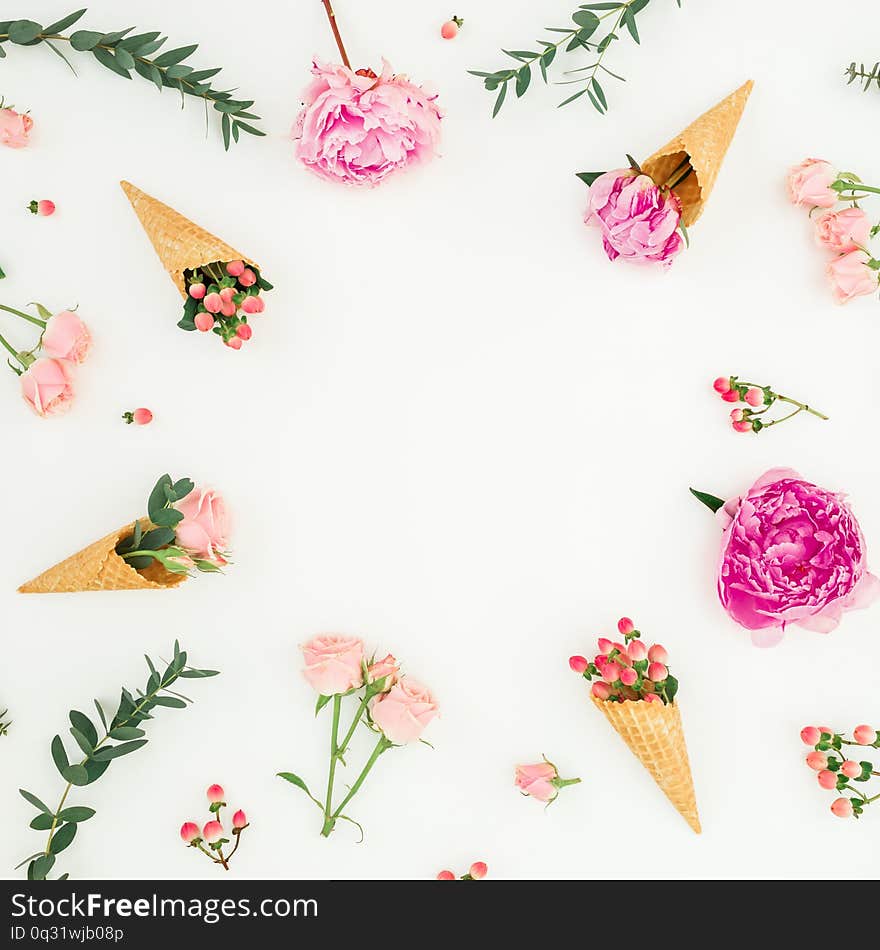 Floral frame with pink peonies, roses petals, eucalyptus, waffle cones on white background. Flat lay