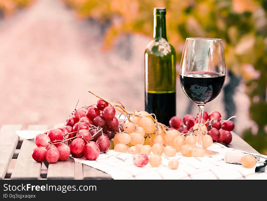 Still life with glass of red wine and grapes