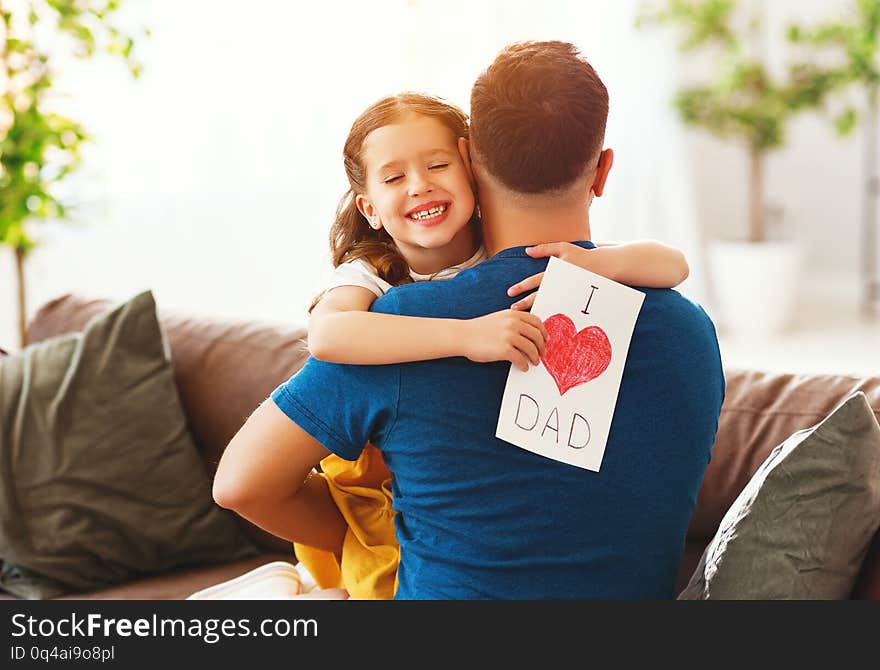 Father`s day. Happy family daughter hugging dad and laughs on holiday