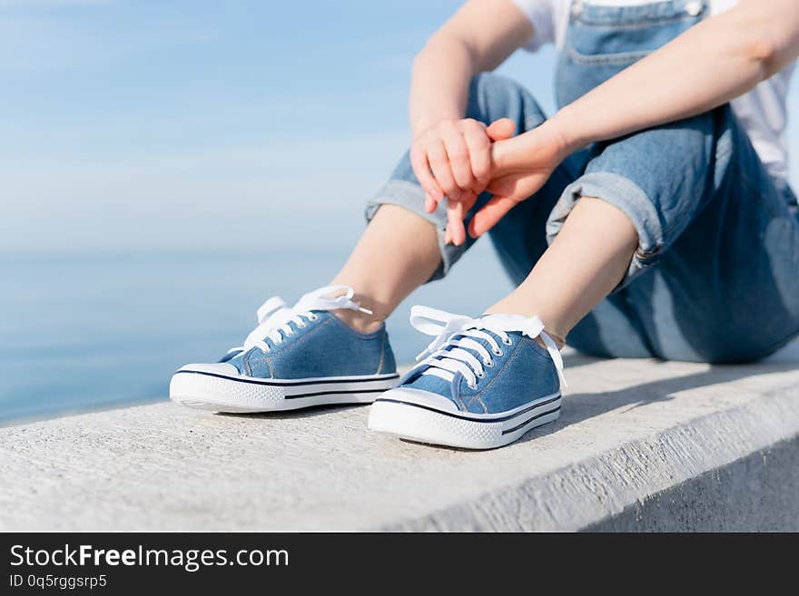 Photo of an adult woman enjoying the sun on the sea coast. Relax.