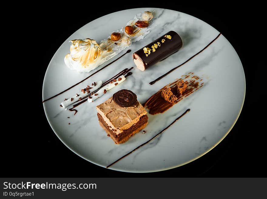 Top view of homemade chocolate and white cream mousse dessert served on round plate on black background. Top view of homemade chocolate and white cream mousse dessert served on round plate on black background