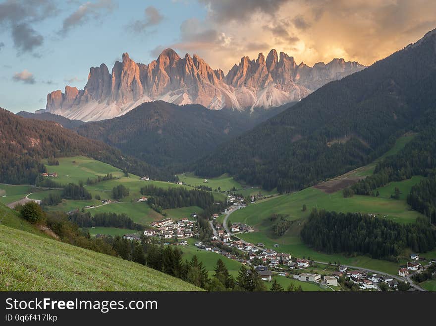 Small Italian mountain town of St. Magdalena in Val di Funes at sunset