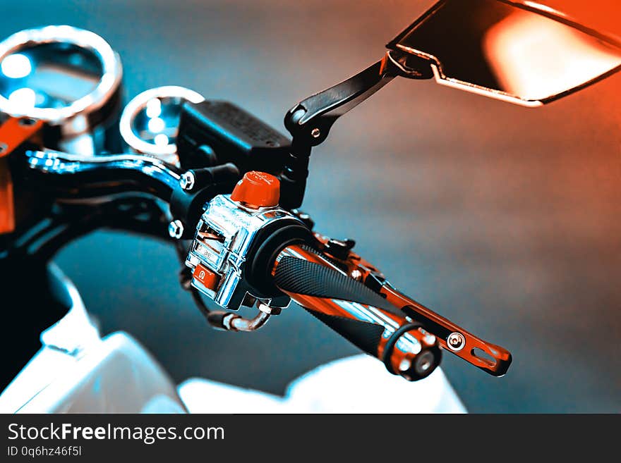 Shiny and clean ATV controls made of metal and rubber. Small details are visible. The background is blurred. Shiny and clean ATV controls made of metal and rubber. Small details are visible. The background is blurred.