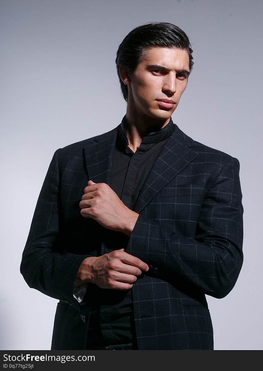 Image of a attractive strong young man in full elegant black suit, isolated on a white background. Image of a attractive strong young man in full elegant black suit, isolated on a white background.