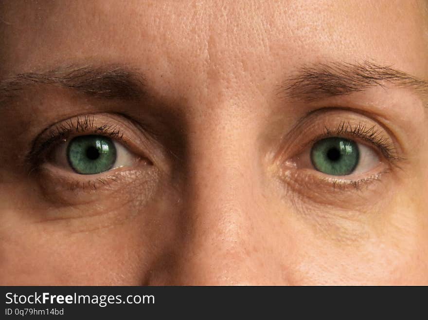 Closeup of middle aged woman eyes. Real  face without make up and correction. Look at camera