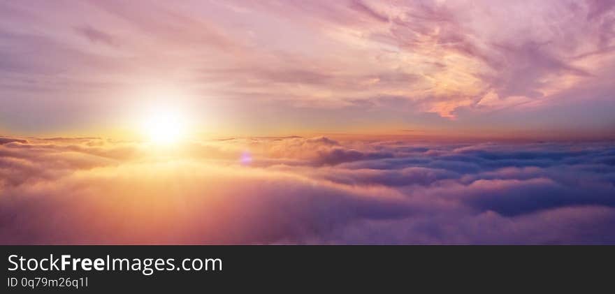 Beautiful sunset cloudy sky from aerial view. Airplane view above clouds. Beautiful sunset cloudy sky from aerial view. Airplane view above clouds