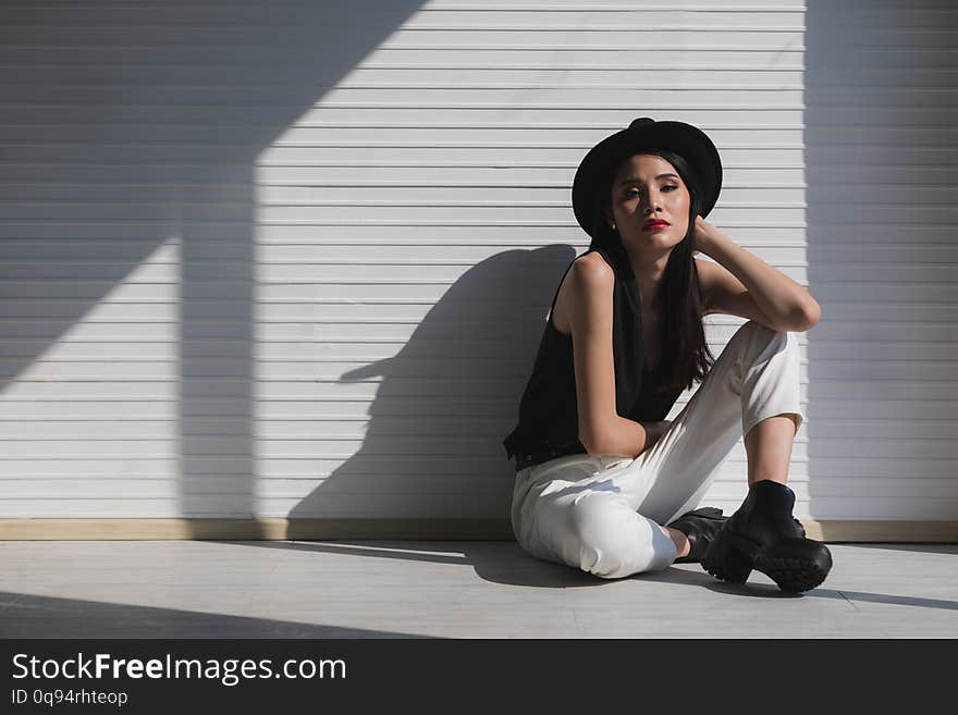 Asian Woman Sitting Near Window