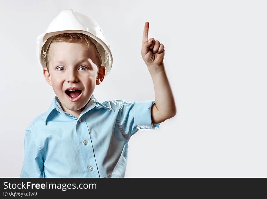 The boy in the light blue shirt and construction helmet of the foreman raised a finger, as if he had found the idea