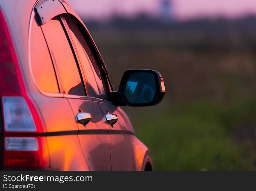 Angle shot of a car against sunset in the background