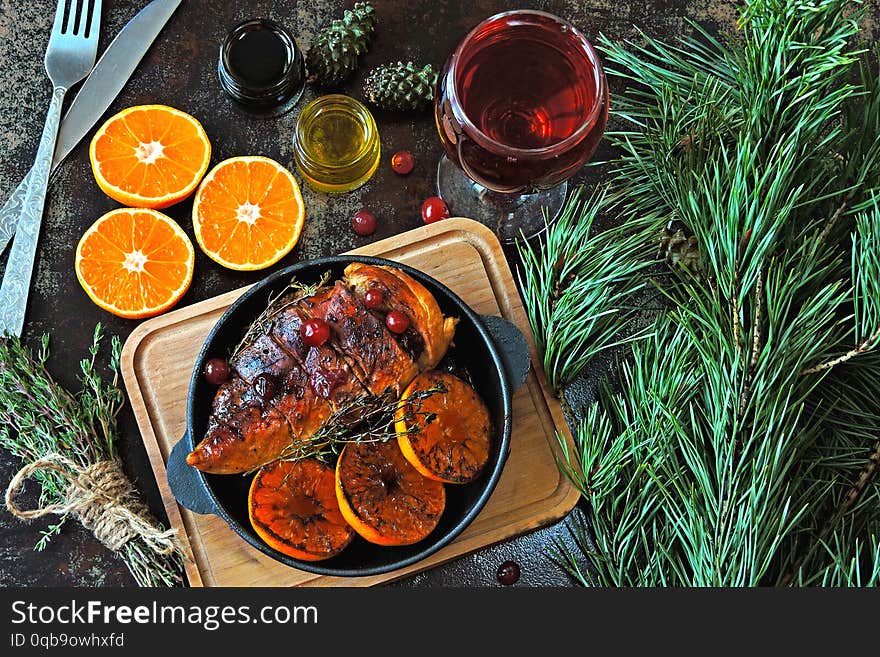 Christmas dinner. Chicken breast baked with tangerines and cranberries. glass of wine. Christmas moo