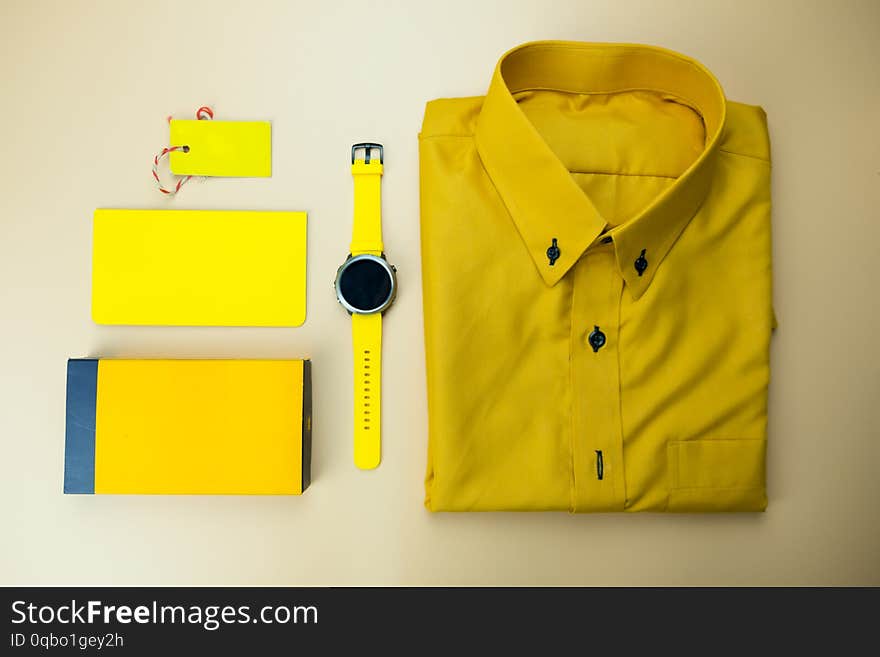 Set of yellow accessories outfits for men on yellow background. Trendy fashion male flat lay background