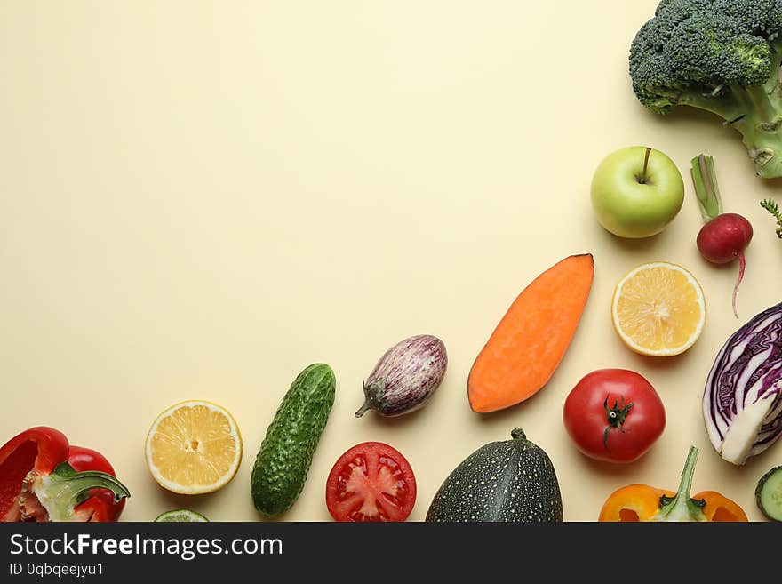 Flat lay composition with fresh ripe vegetables and fruits on color background. Space for text