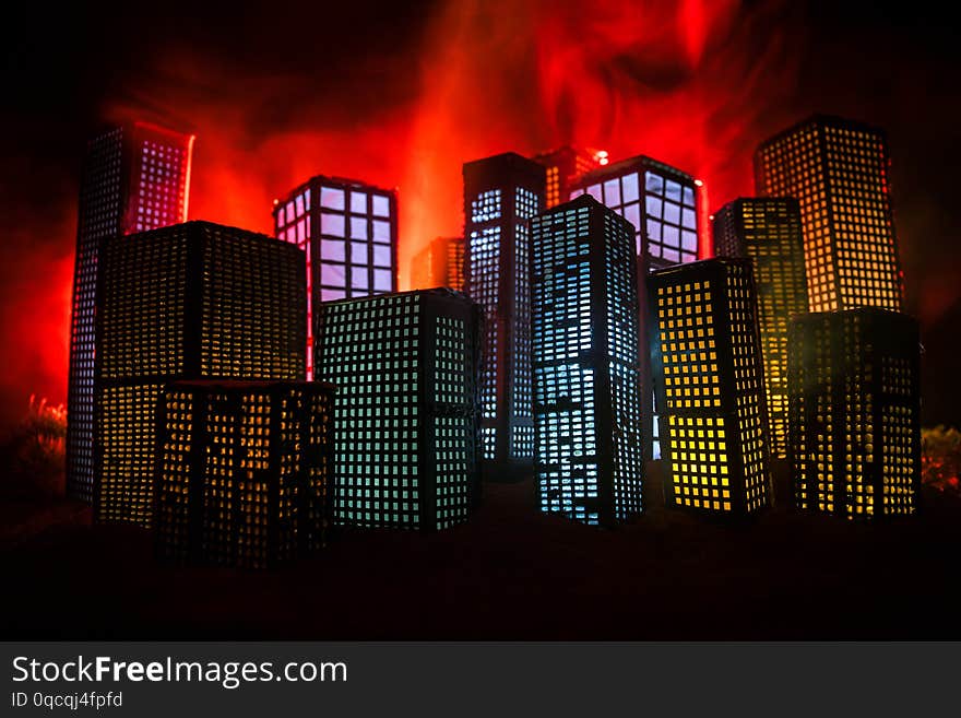 Creative artwork table decoration with little city buildings glowing at night. Modern city buildings, bright glowing lights