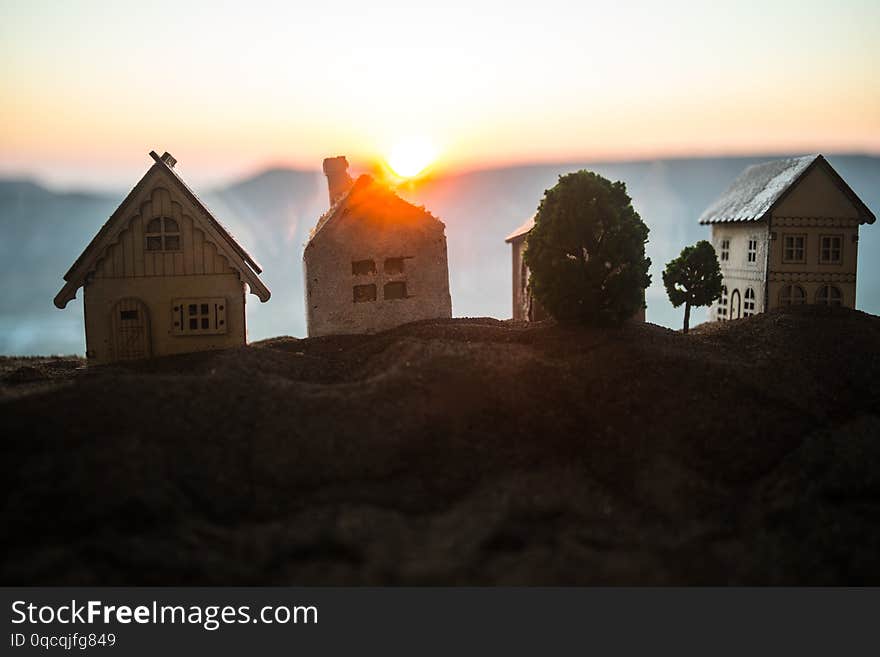 Artwork Decoration. Beautiful decorative small wooden houses on sunset background. Selective focus. Artwork Decoration. Beautiful decorative small wooden houses on sunset background. Selective focus