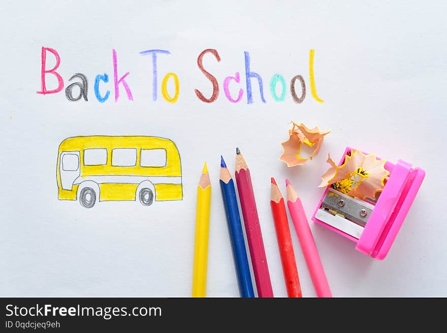 Back to school - colorful crayons on white paper. Back to school - colorful crayons on white paper