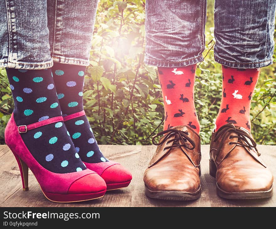 Men`s and women`s legs, bright socks. Close-up