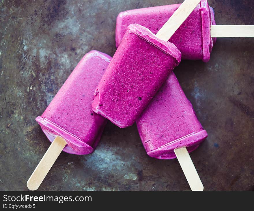 Bright ice cream on a dark surface. Black, isolated background. Close-up, top view. Concept of tasty and healthy food