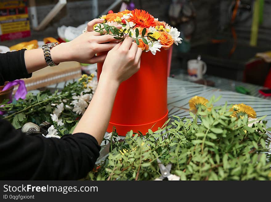 The hands of the florists make a bouquet. woman`s hands make a floral arrangement. florist makes a gift bouquet in a flower shop