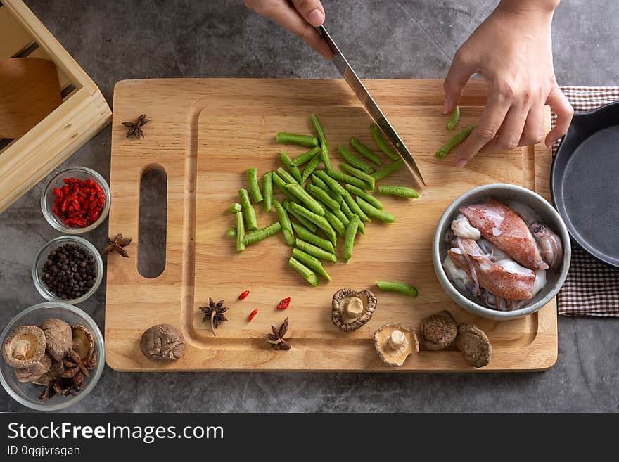 Top View of Hands Sliced lentils On a cutting board In making healthy food menus From many squid and spices. Top View of Hands Sliced lentils On a cutting board In making healthy food menus From many squid and spices