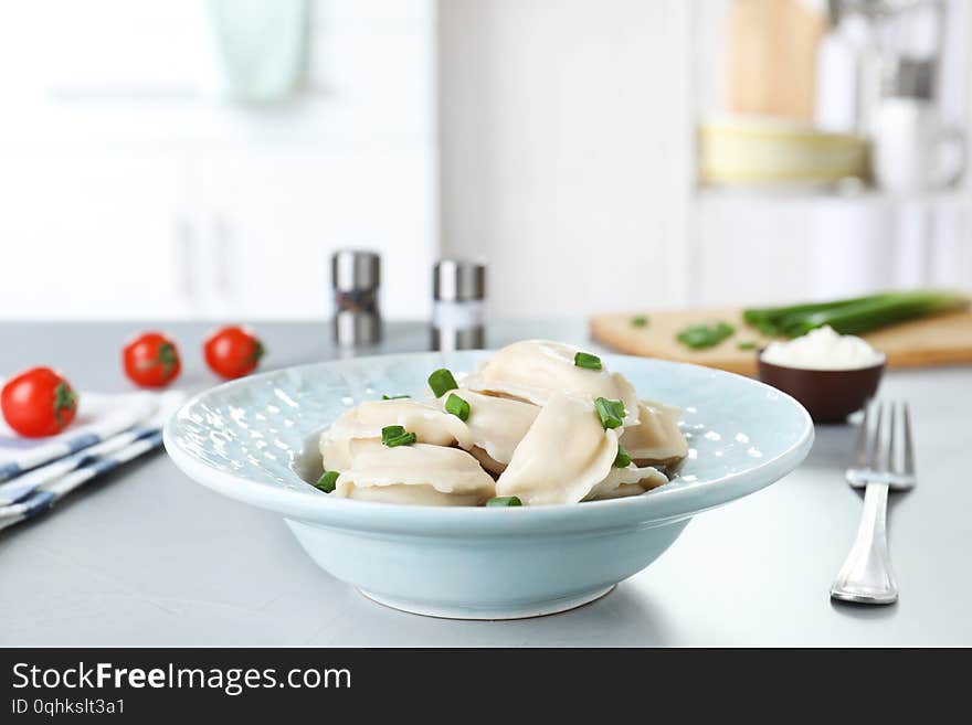 Plate of tasty dumplings served with green onion