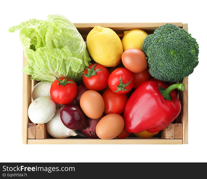 Wooden crate full of fresh products on white background