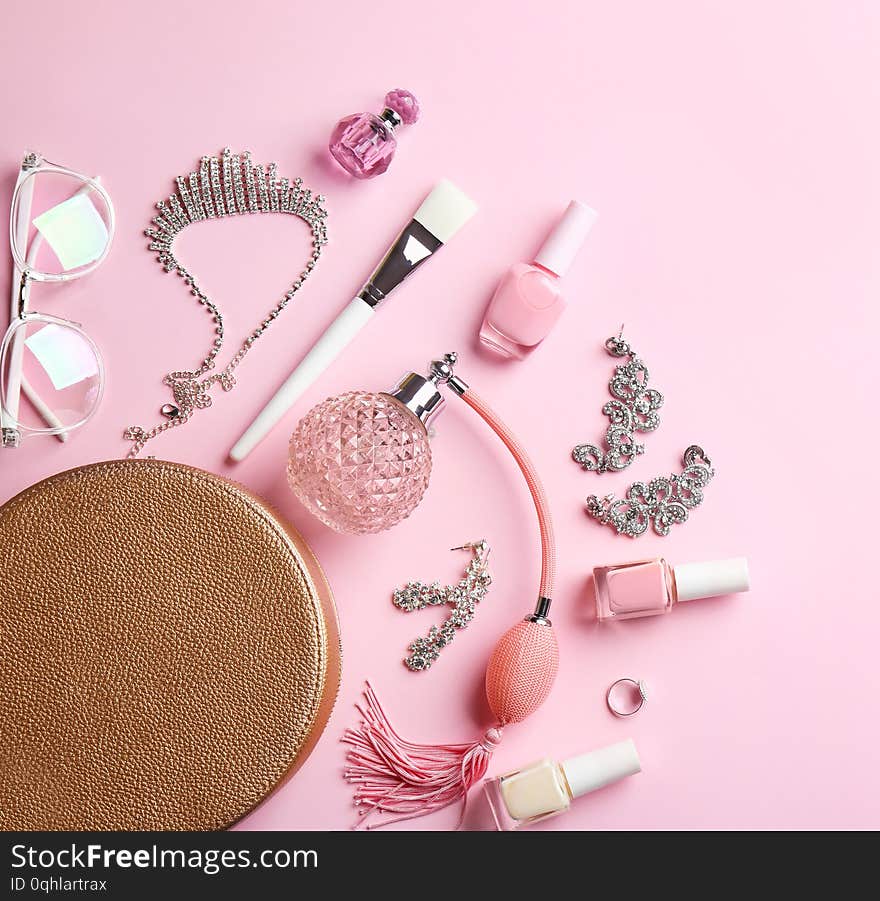 Composition with perfume bottles, cosmetics and jewellery on color background, flat lay