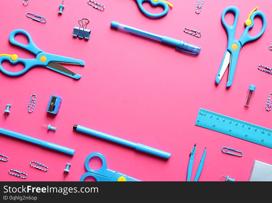 Flat lay composition with scissors and school supplies on color background. Space for text