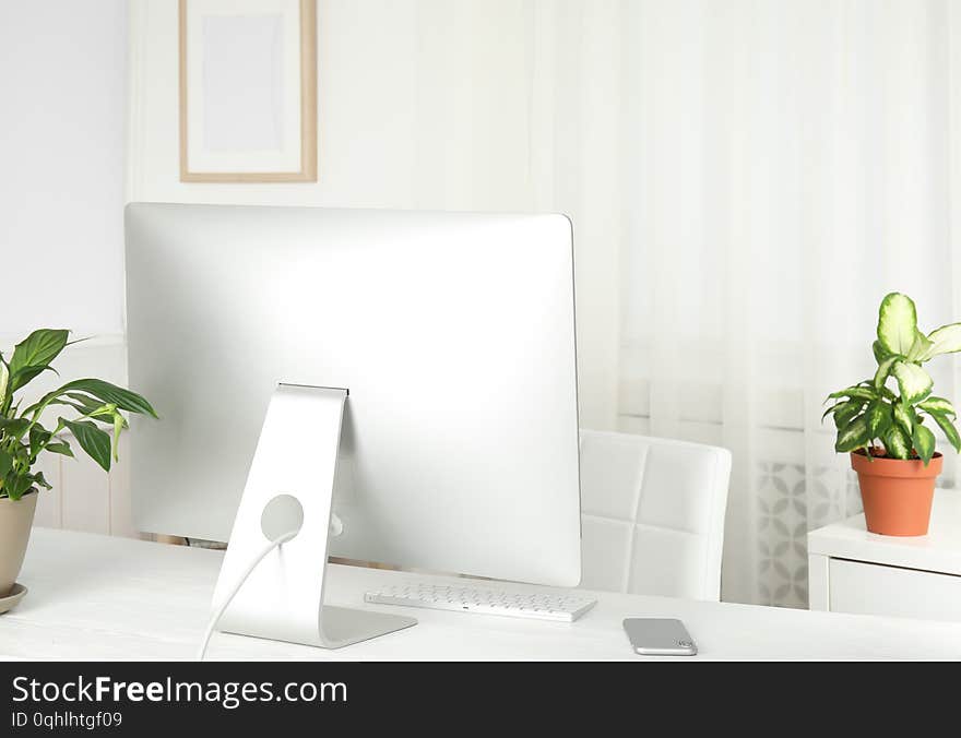 Office Interior With Houseplants And Computer Monitor