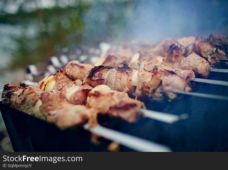 Smoky grilling the marinated pork meat shashlik. Cooking barbecue. Smoky grilling the marinated pork meat shashlik. Cooking barbecue