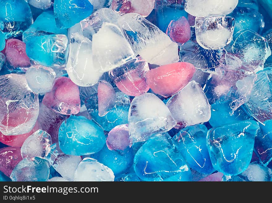 Background with transparent, white, pink and blue ice cubes. Fresh summer pattern. Flat Lay