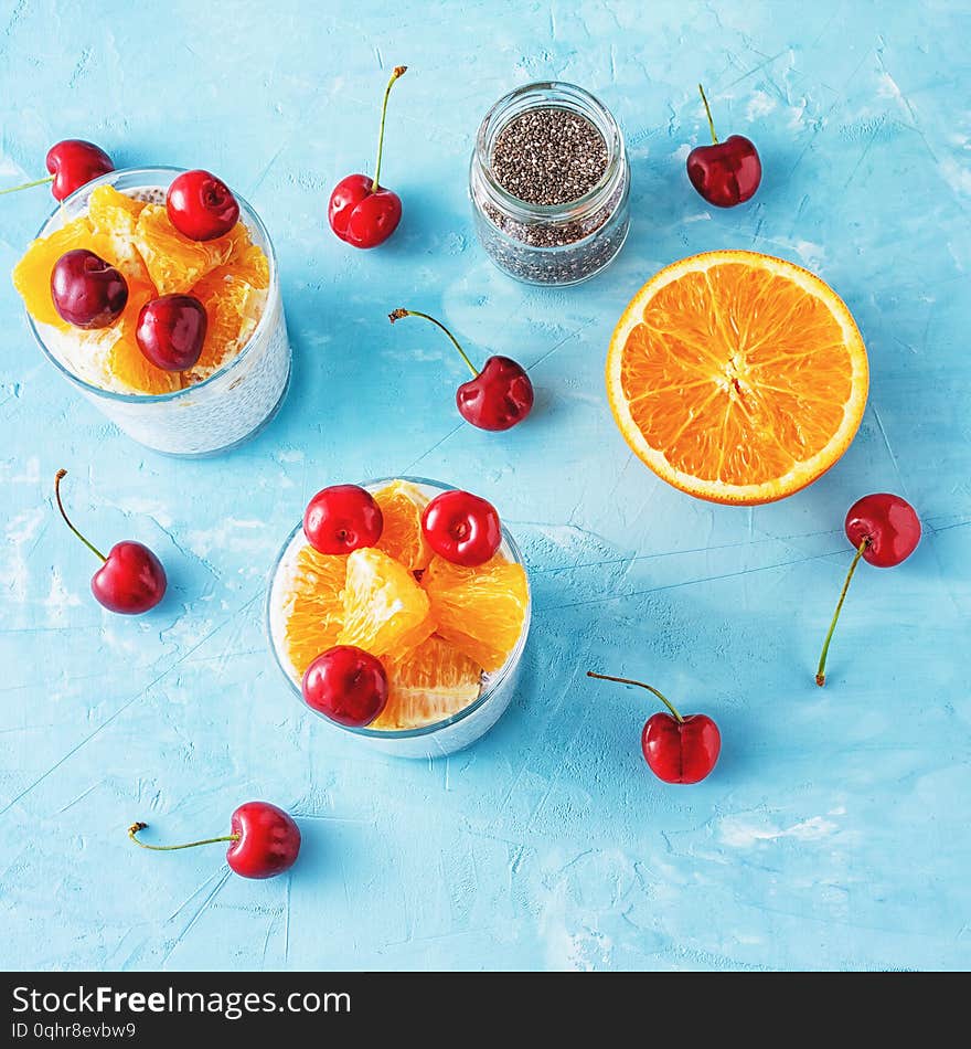 Cottage Cheese Chia Seeds Nutritious Breakfast. Yogurt Dessert with Fruit Adding Flatlay. Mousse Serving, Orange, Cherry and Glass Jar with Superfood on Neutral Background. Healthy Eating