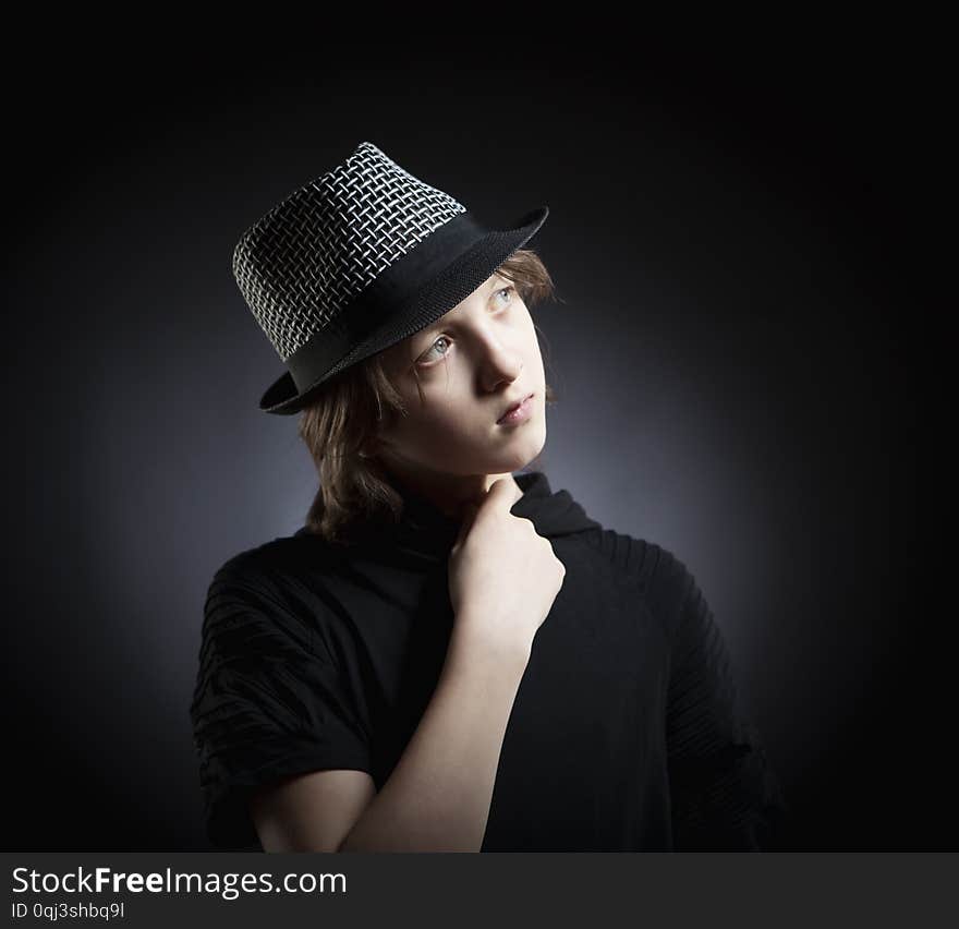 Boy With Blond Hair In Hat And Black Top